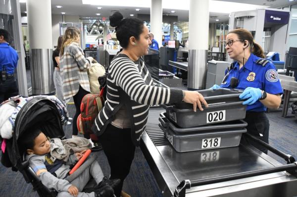 TSA agents scan luggage.