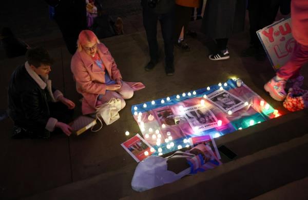 Vigil for Brianna Ghey, trans rights flag and lights on ground