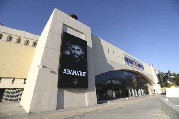 A banner depicting AEK Athens fan Michalis Katsouris, who died from a stab wound, reads "Immortal" outside AEK's Opap Arena, in Athens on Friday.