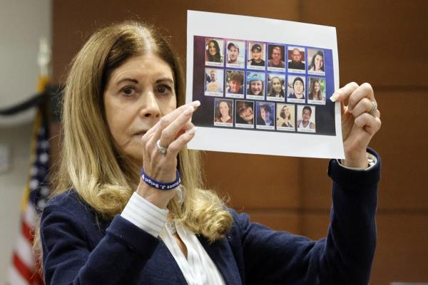 Linda Beigel Schulman displays a composite photo of the 17 murdered students and staff as she gives her victim impact statement.